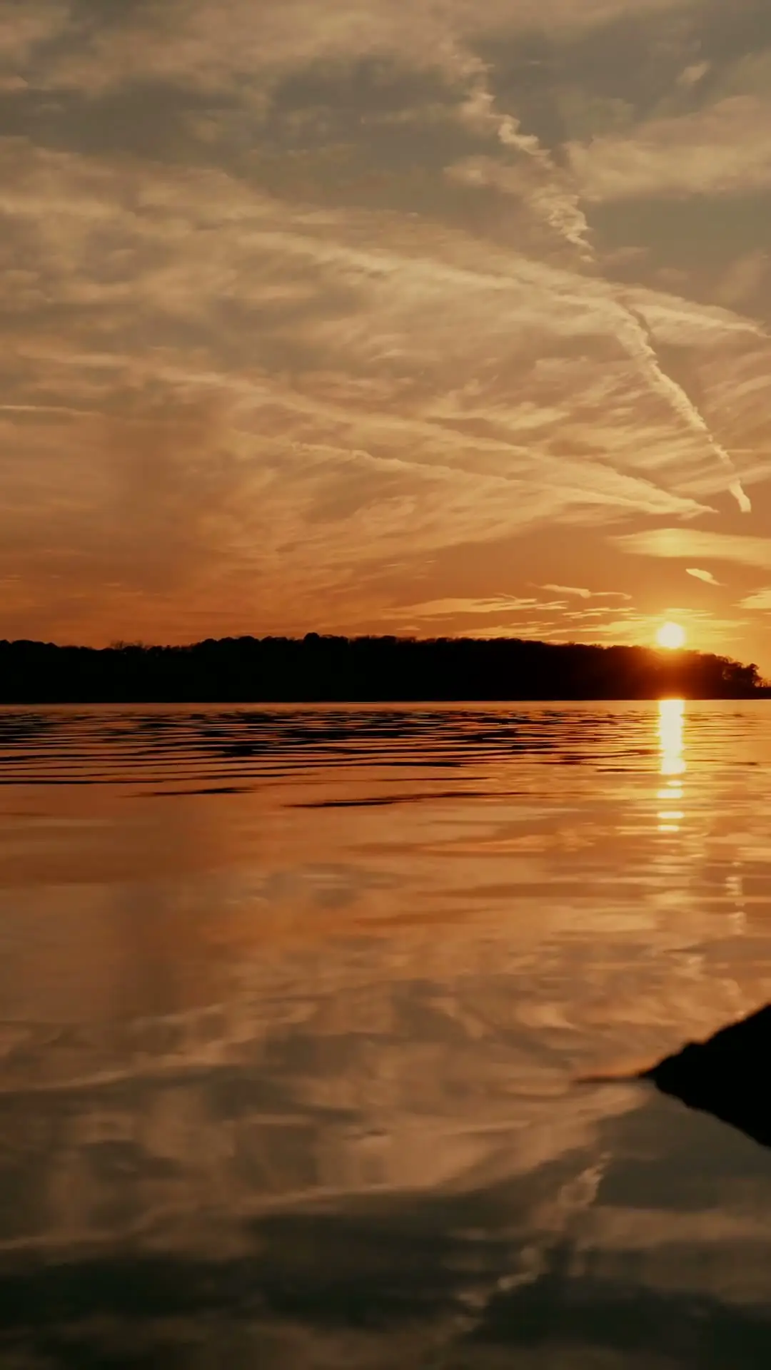 A calm lake reflecting the last light of night